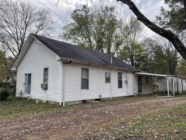 a view of house with a backyard space