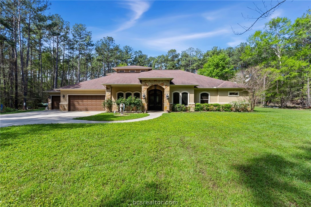 a front view of house with yard and green space