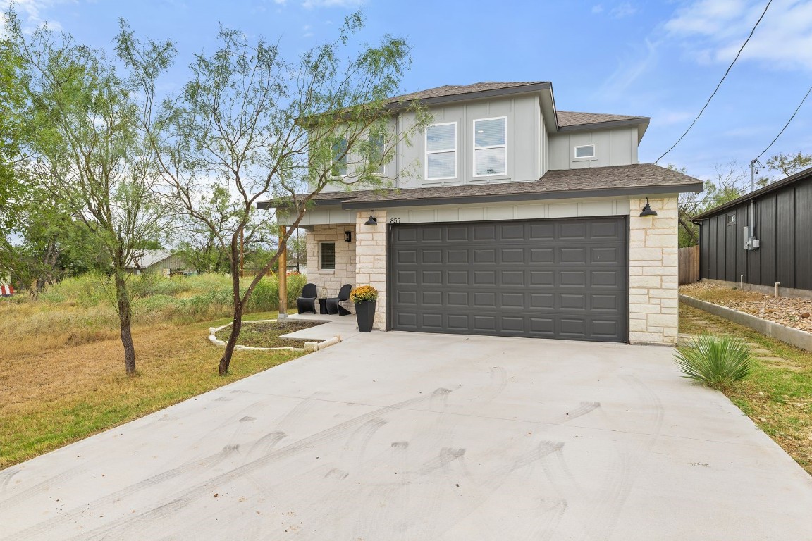 a front view of a house with a yard and garage