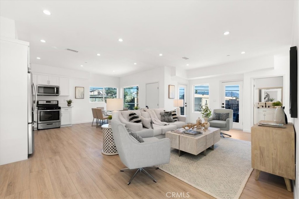 a living room with furniture and kitchen view