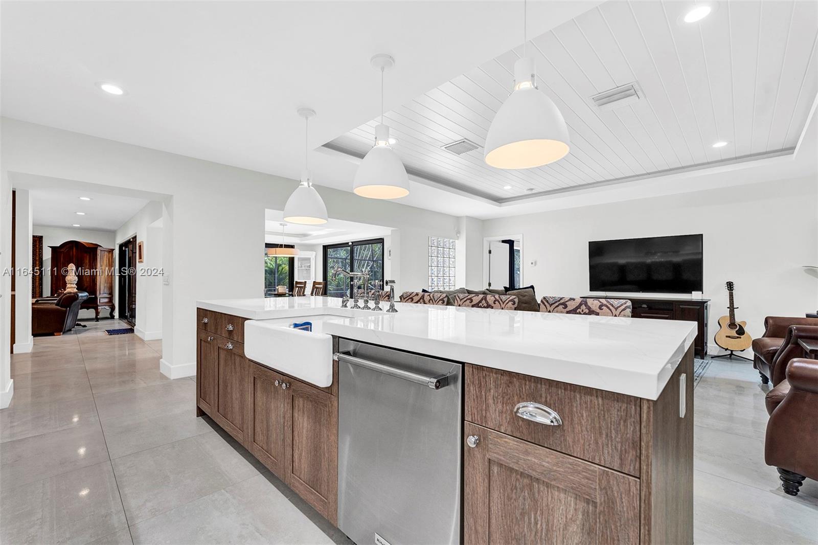 a large white kitchen with a large window