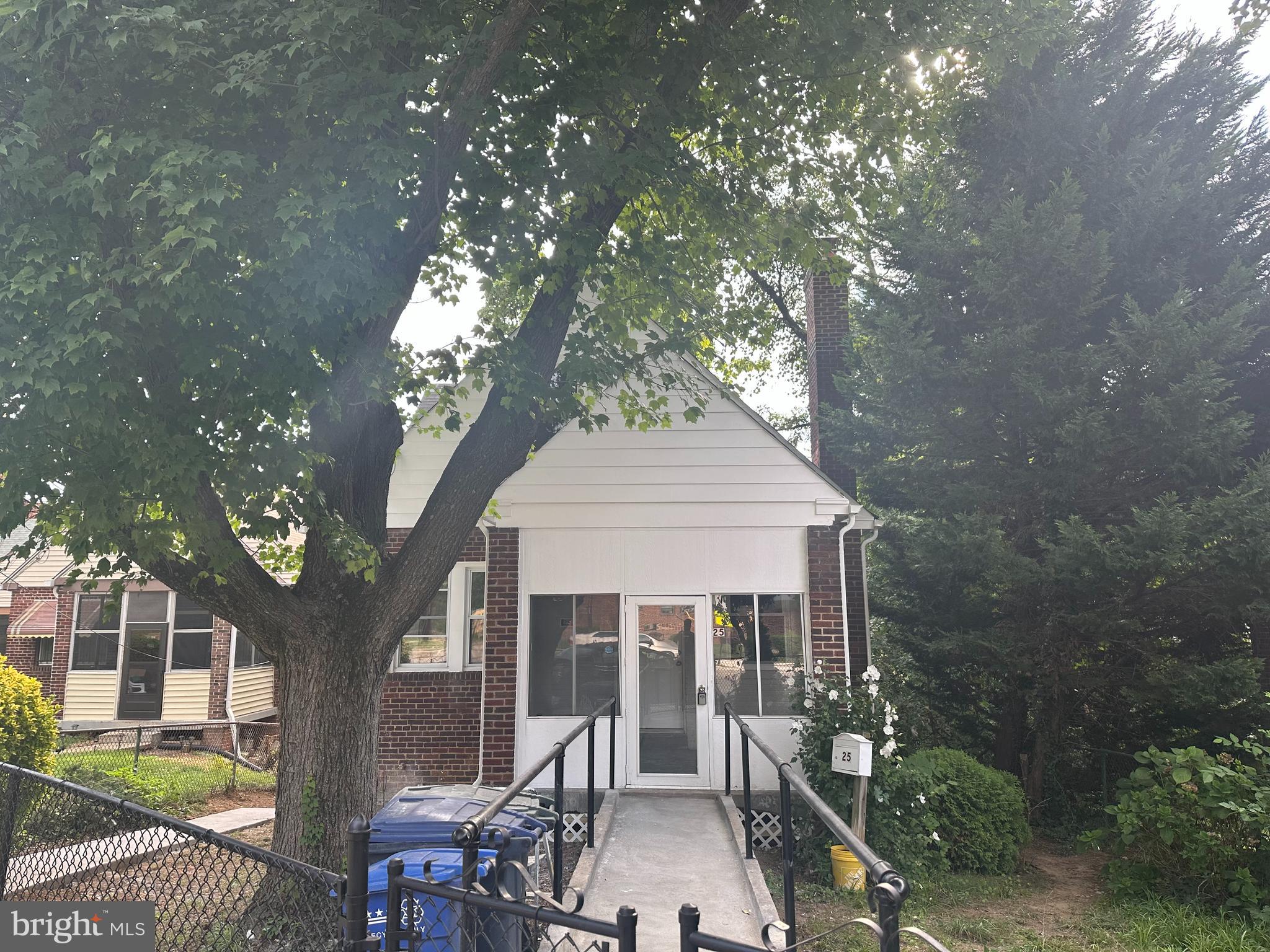 a view of a house with a tree in front of it