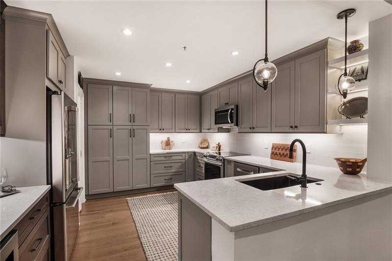 a kitchen with refrigerator cabinets and a sink