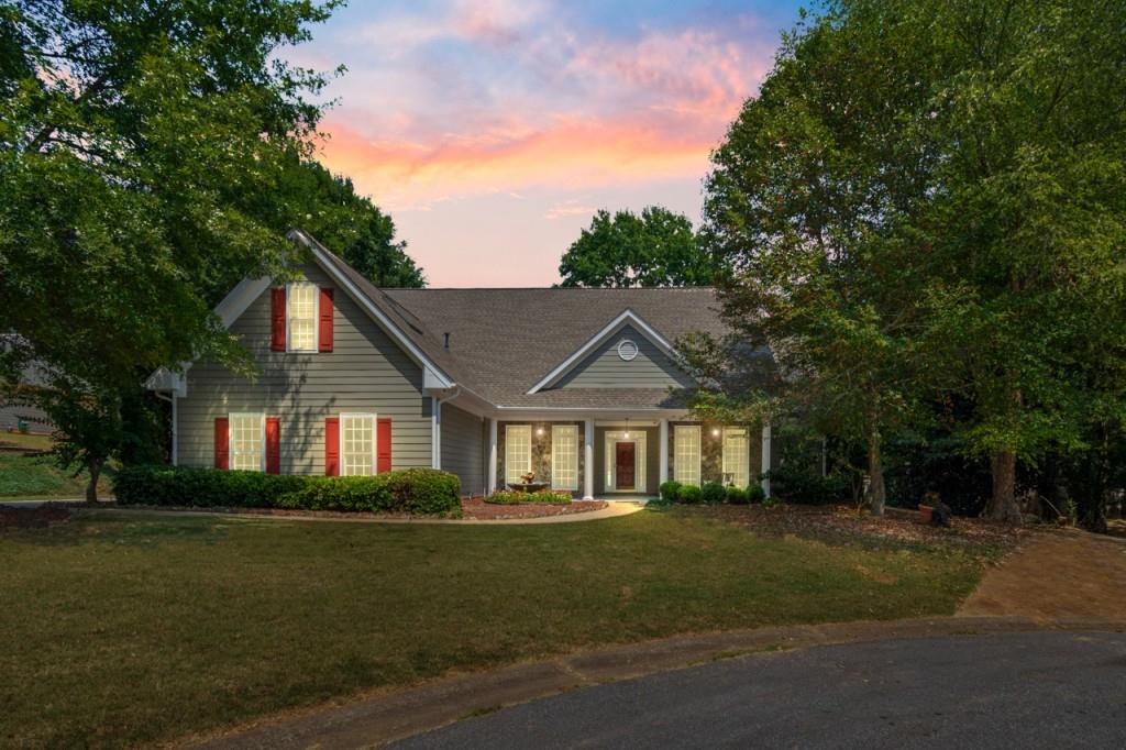 a front view of a house with a garden