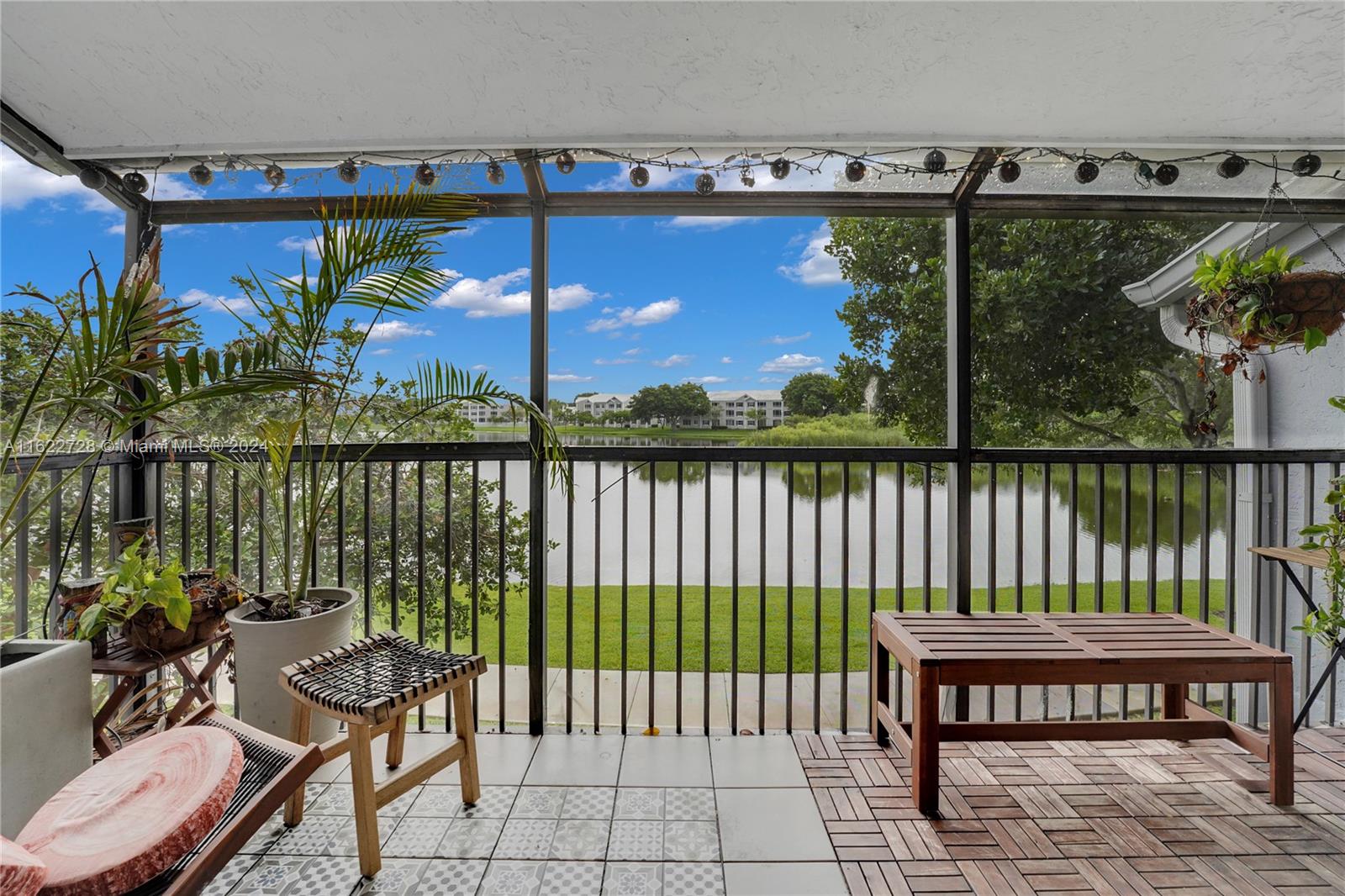 a view of a balcony with wooden floor and outdoor seating