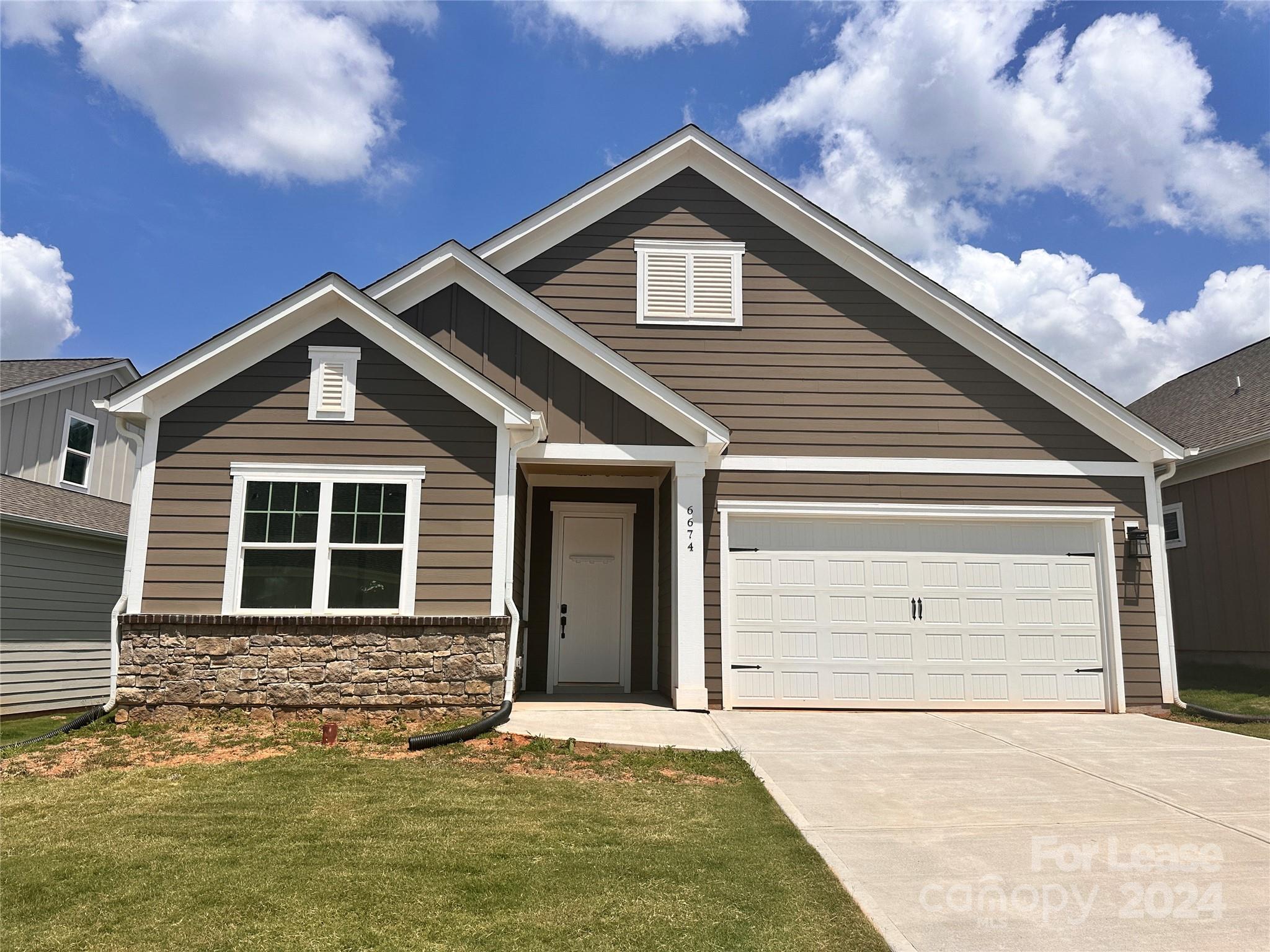 a front view of a house with garage