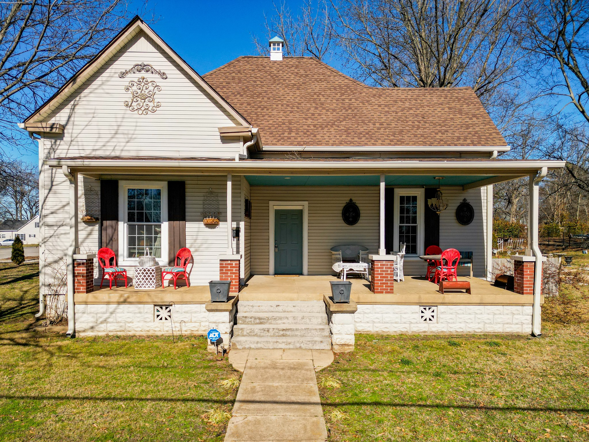 a view of a house with swimming pool and porch with furniture