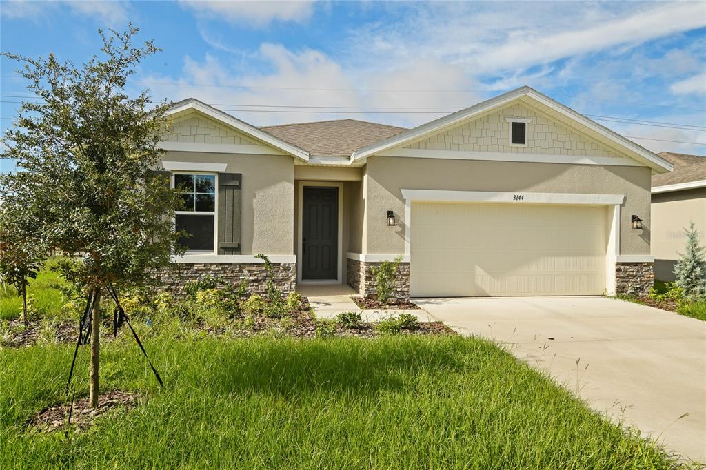 a front view of a house with a yard