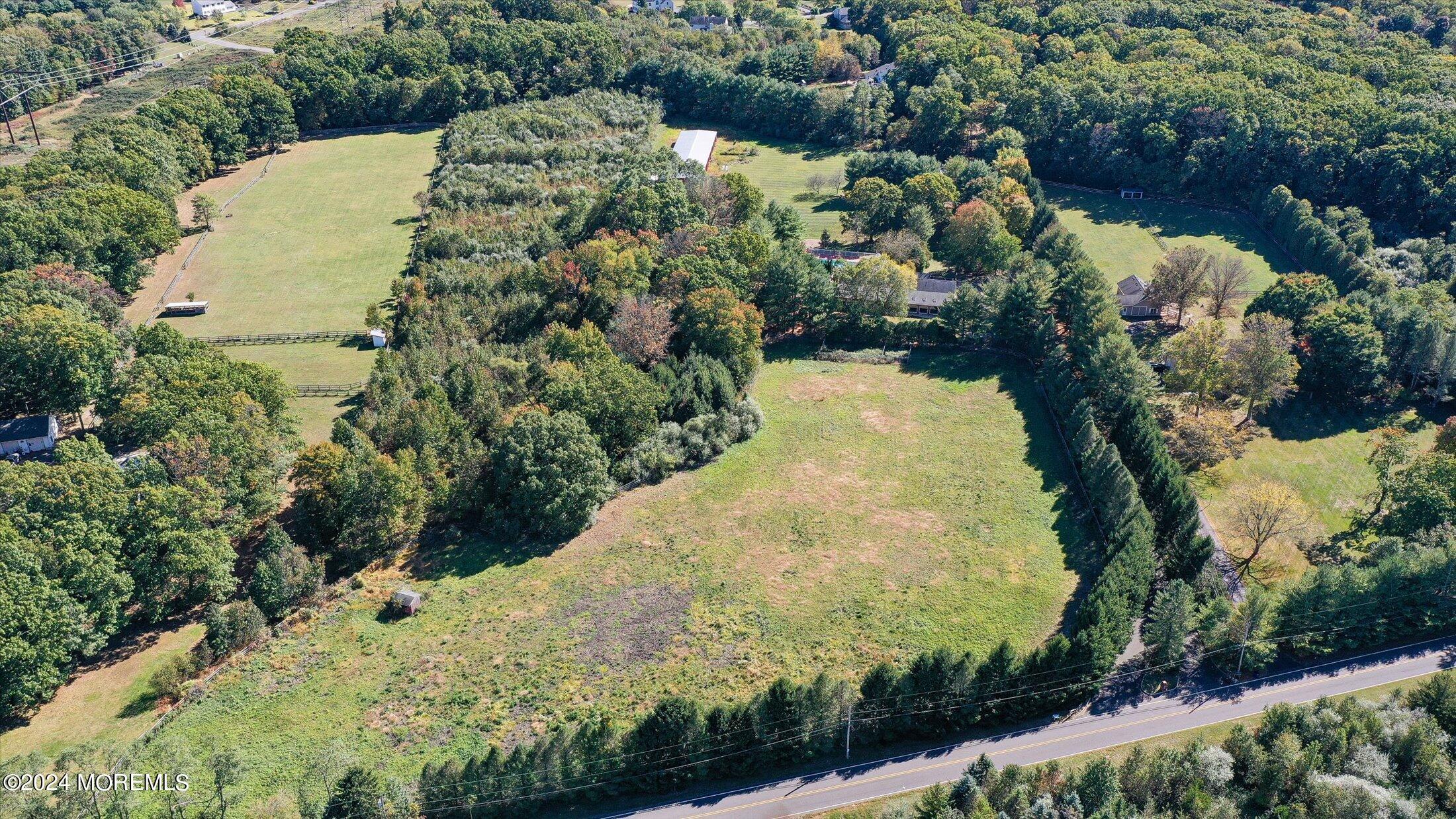 a view of a yard along with trees and houses