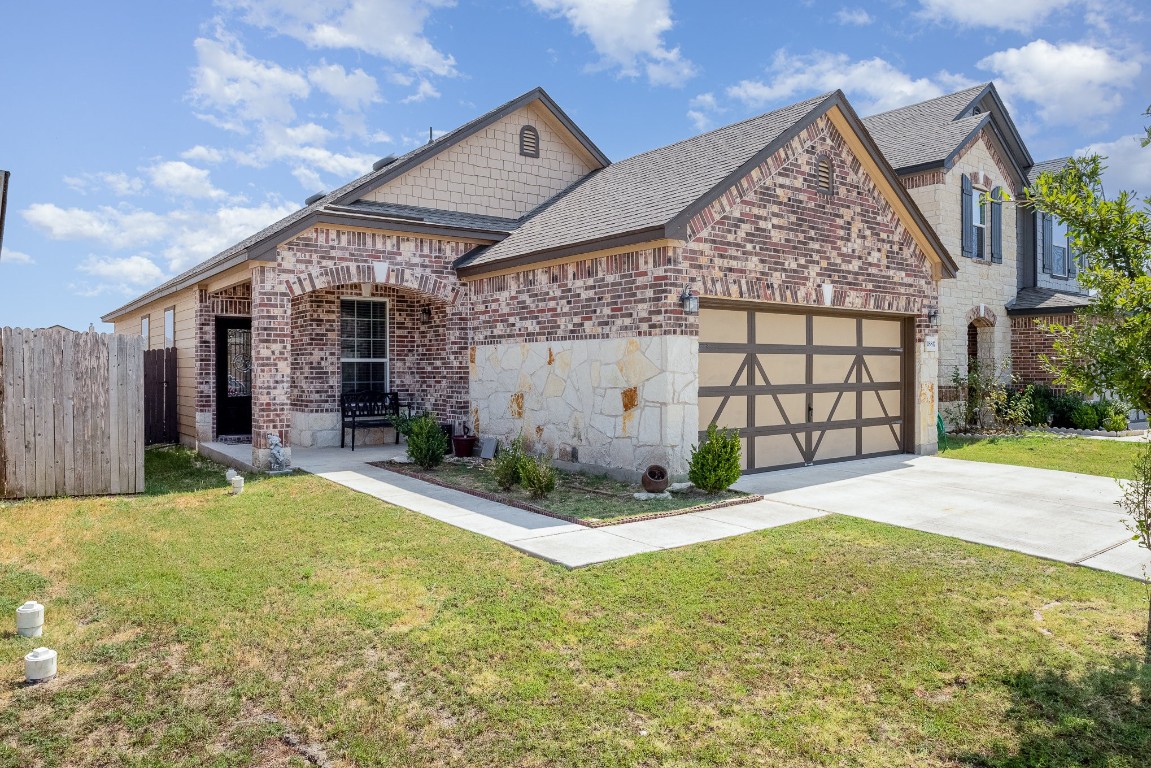 a front view of a house with a yard and garage