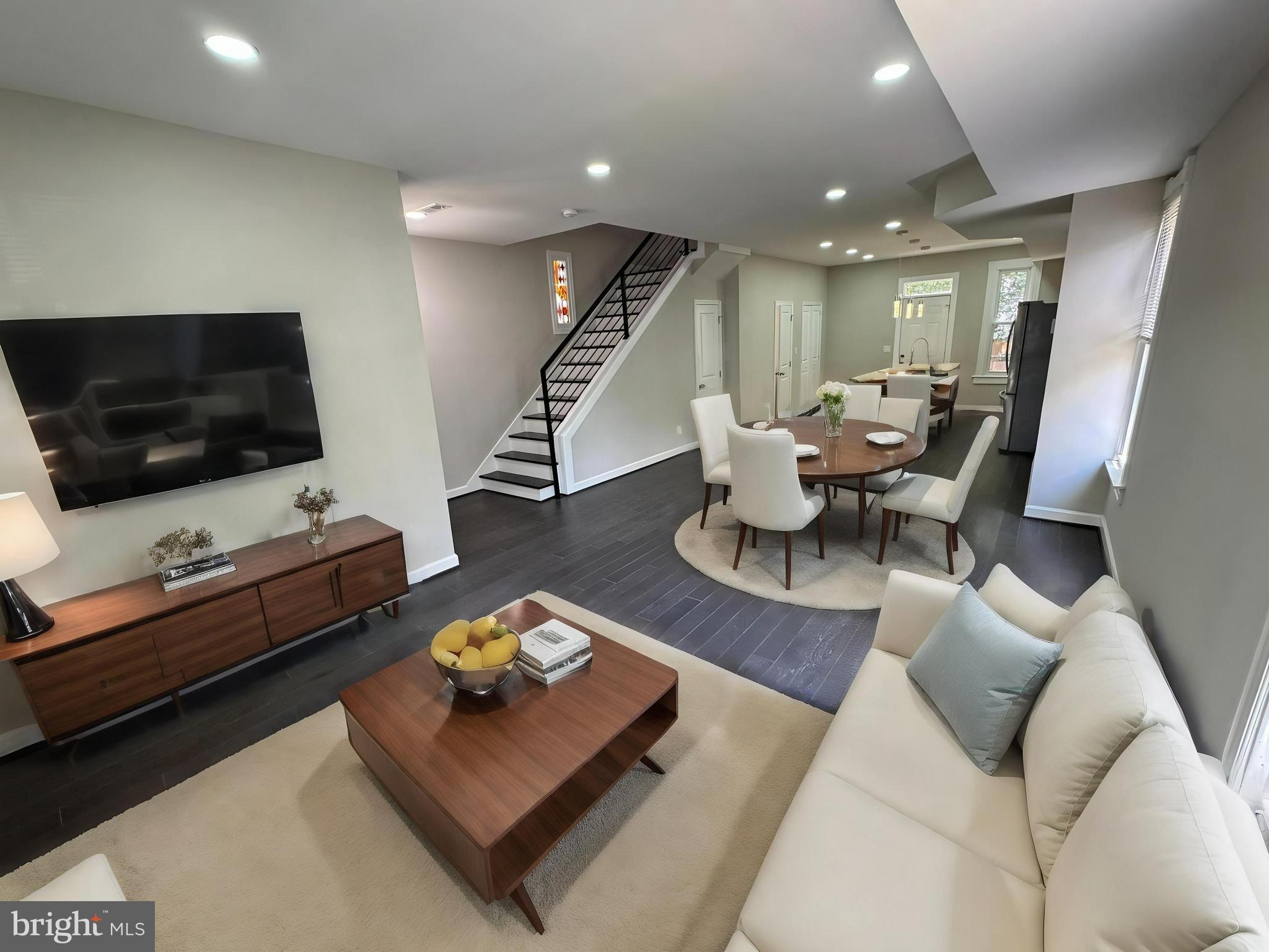 a living room with furniture and a flat screen tv