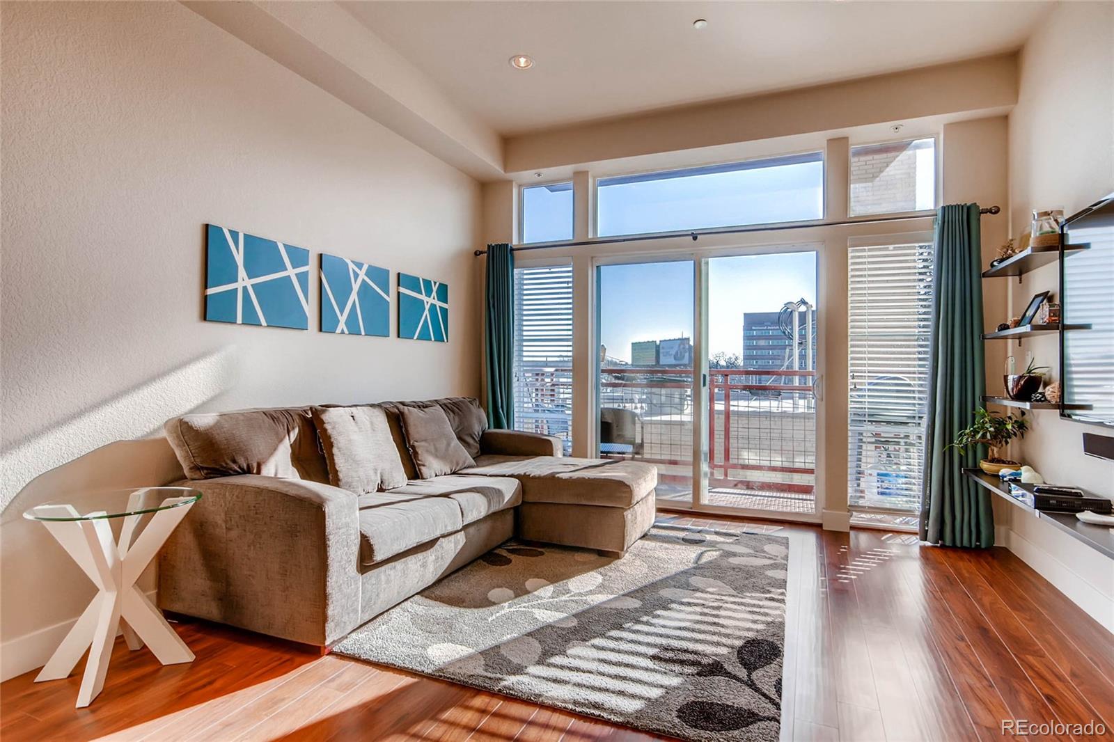 a living room with furniture and a floor to ceiling window or wooden floor