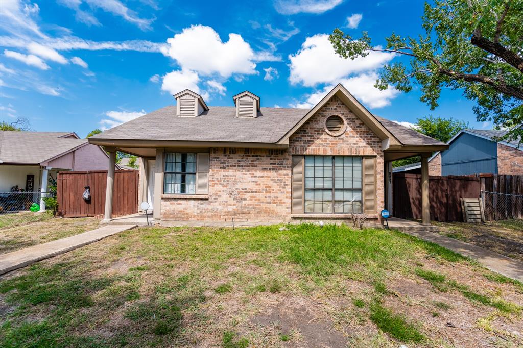 a front view of a house with a yard outdoor seating and garage