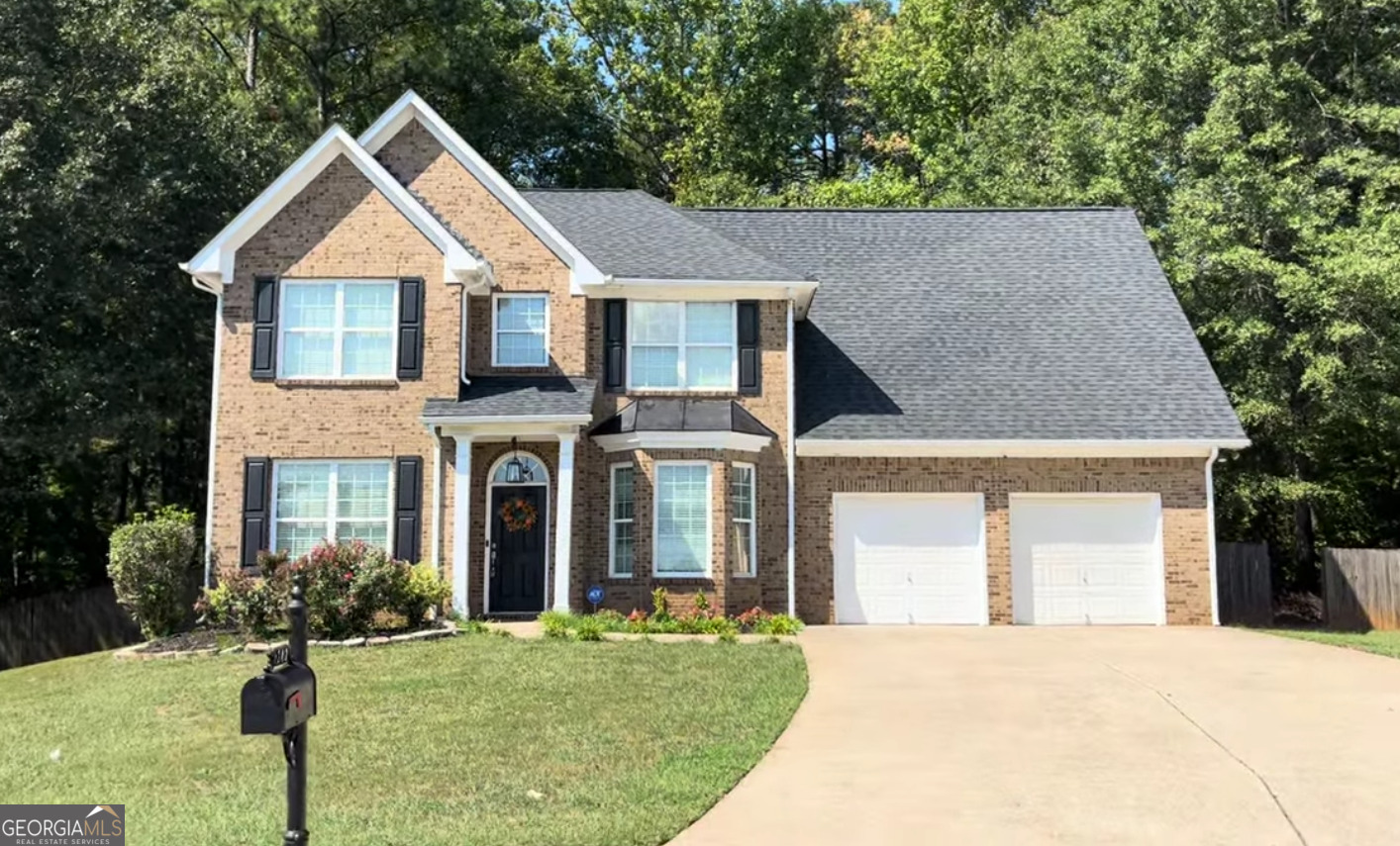 front view of a house with a yard