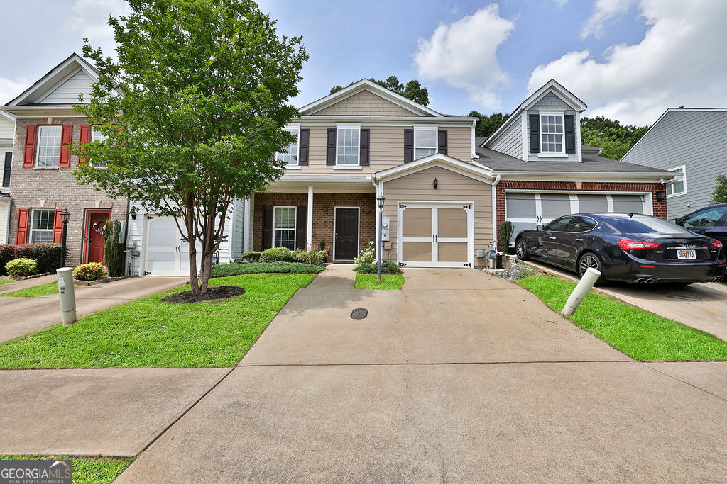 a front view of a house with a garden