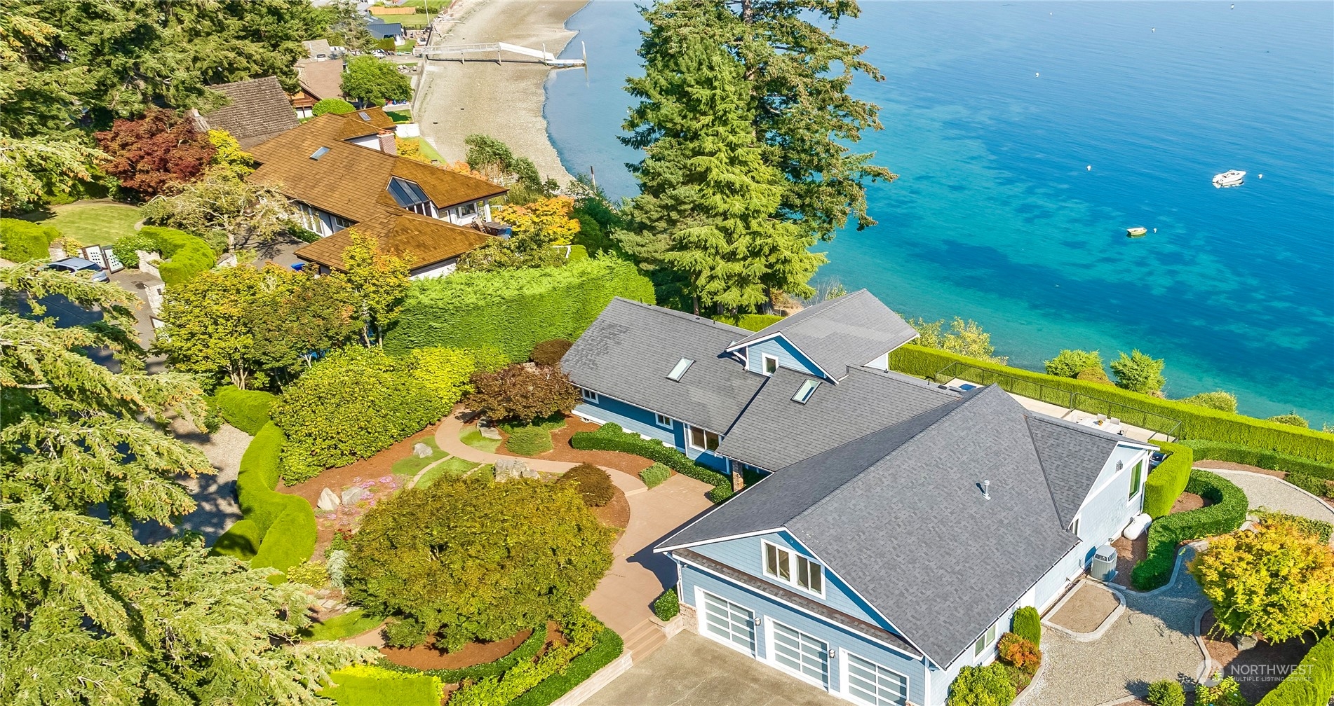 an aerial view of a house with a yard and garden