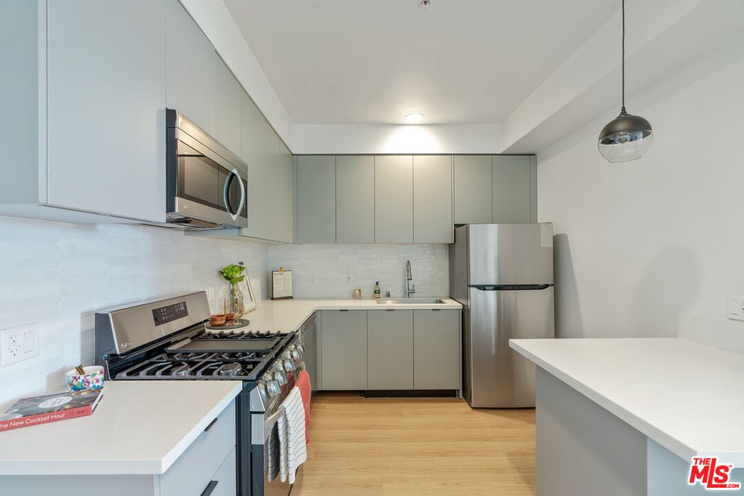 a kitchen with a stove a sink and a refrigerator