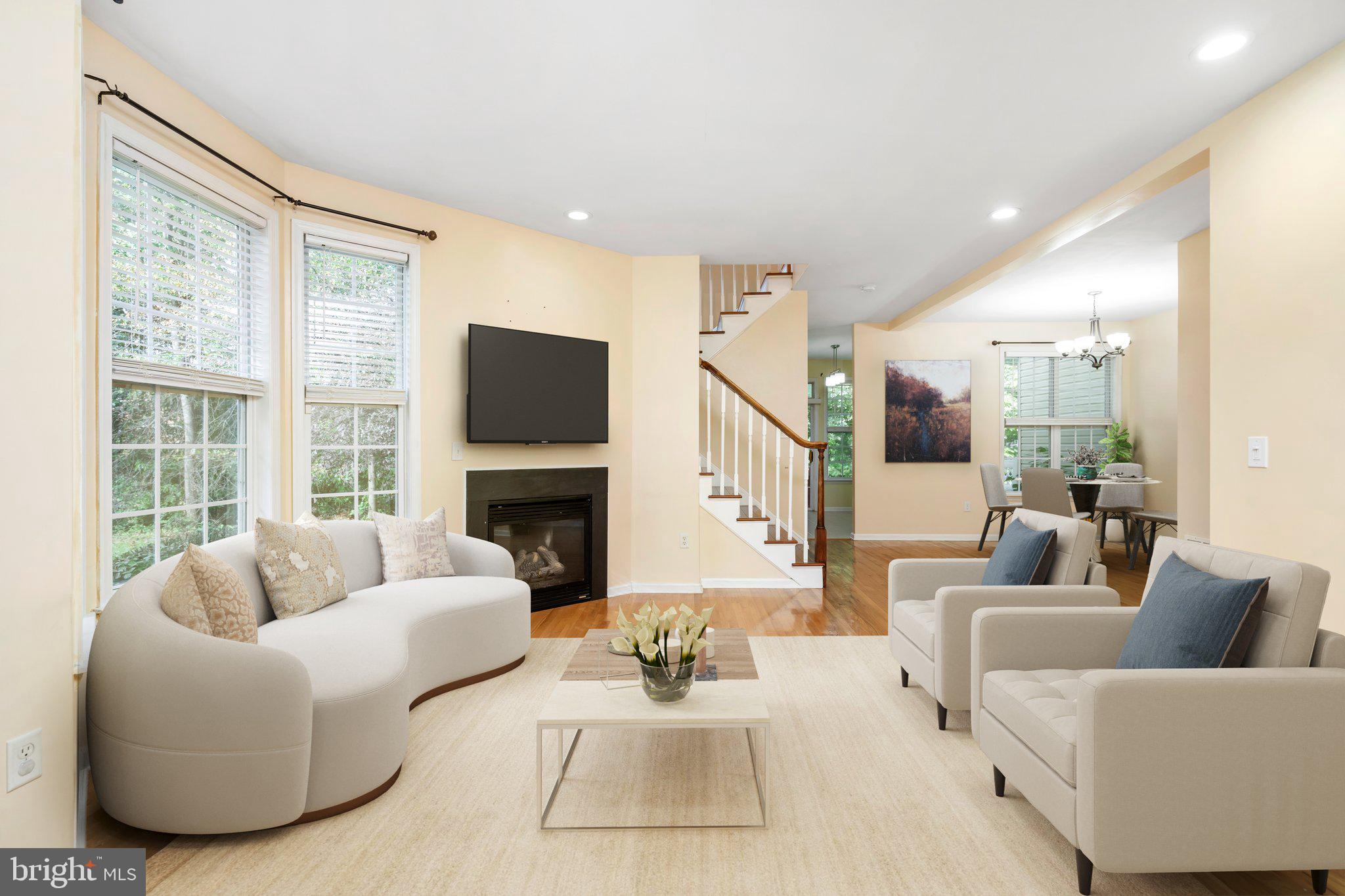 a living room with furniture large window and a fireplace