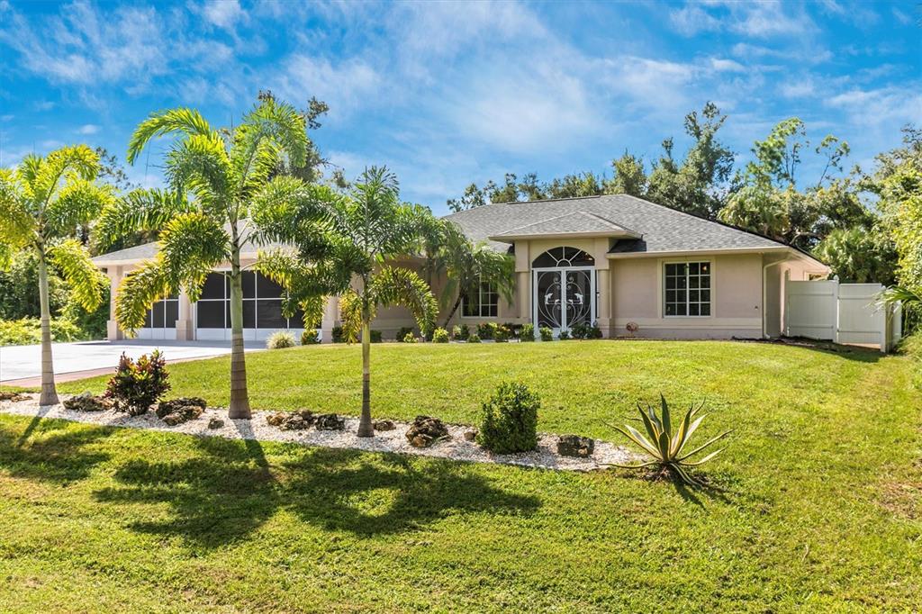 a front view of house with yard and green space