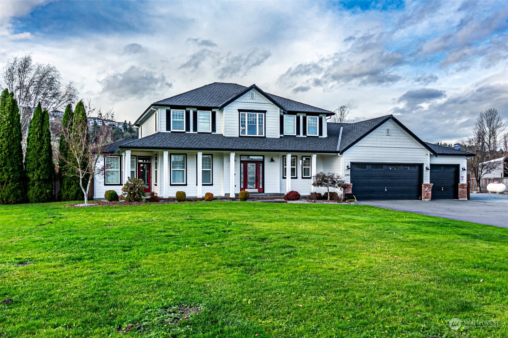 a front view of a house with a garden and porch