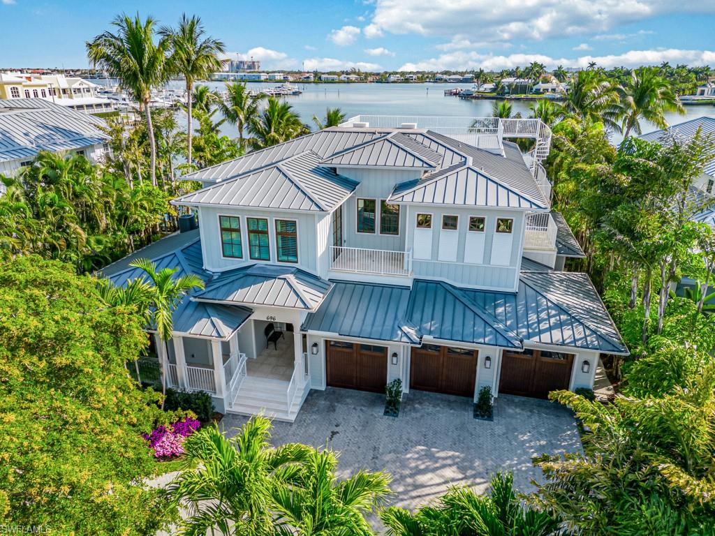 an aerial view of a house with a yard and sitting area