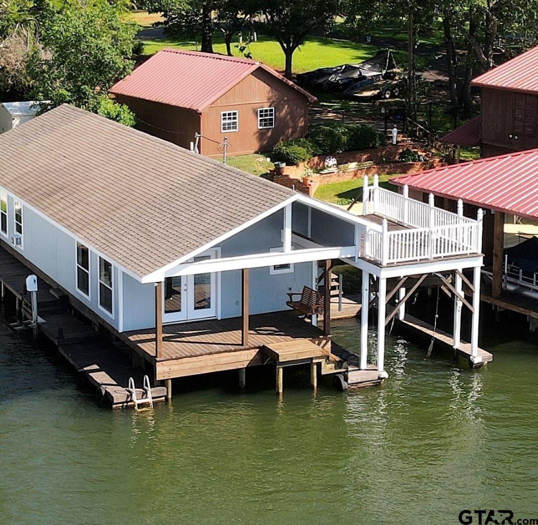 a aerial view of a house with swimming pool and a yard