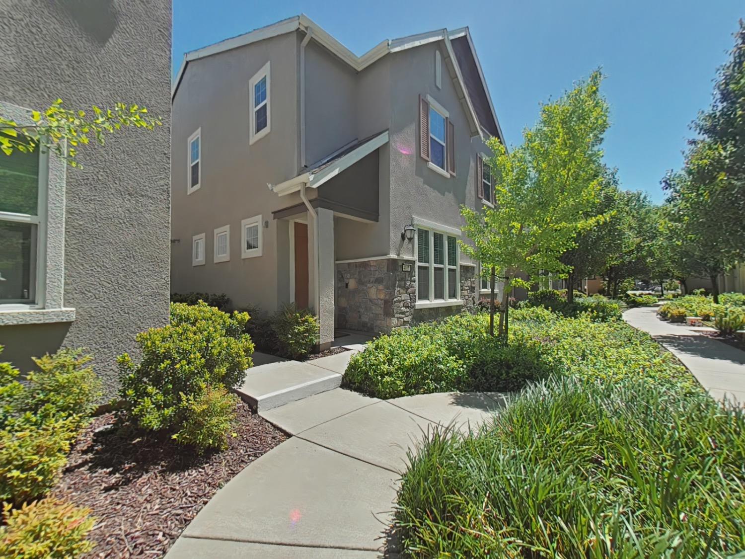 a front view of a house with garden