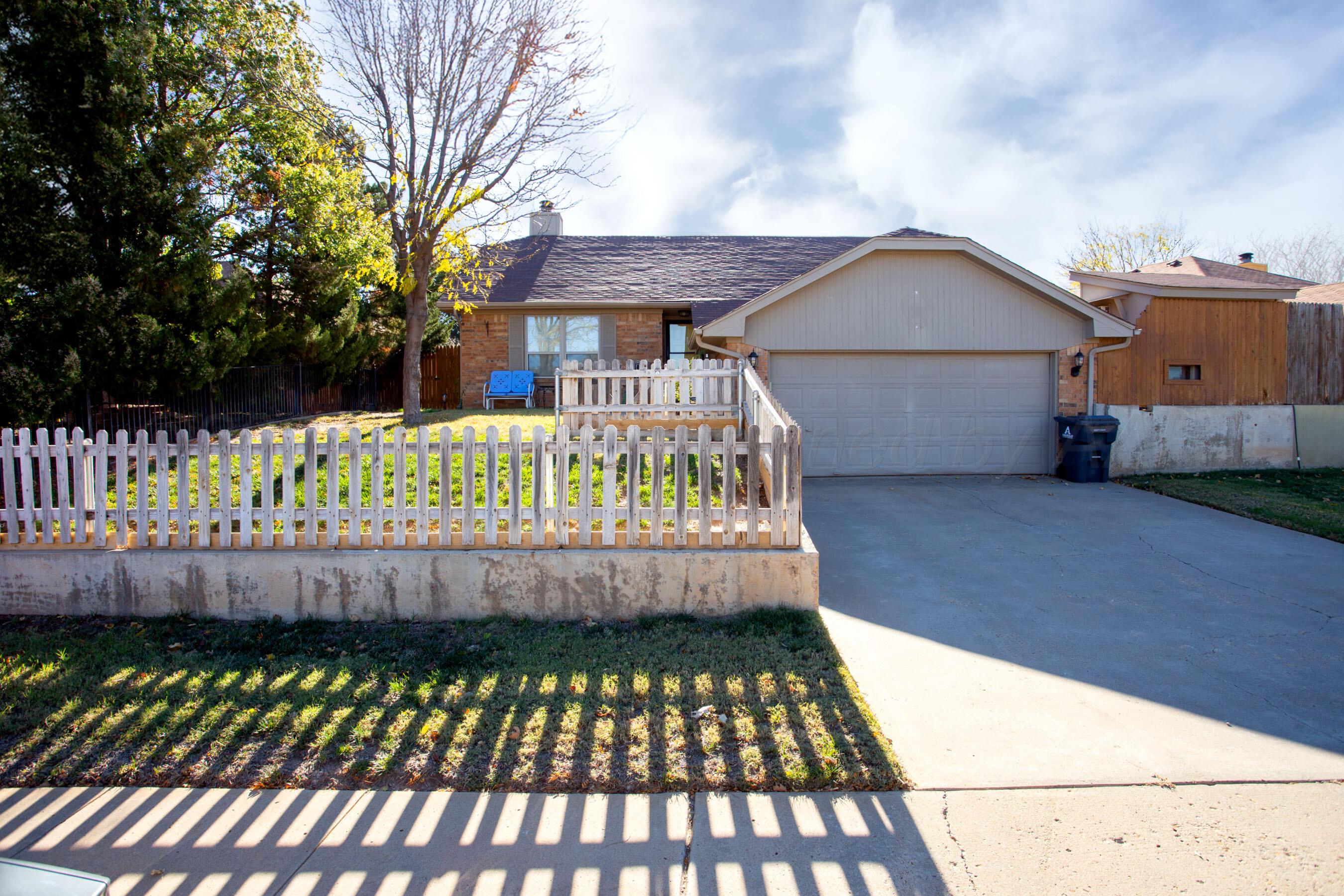 a wooden bench sitting in front of a house