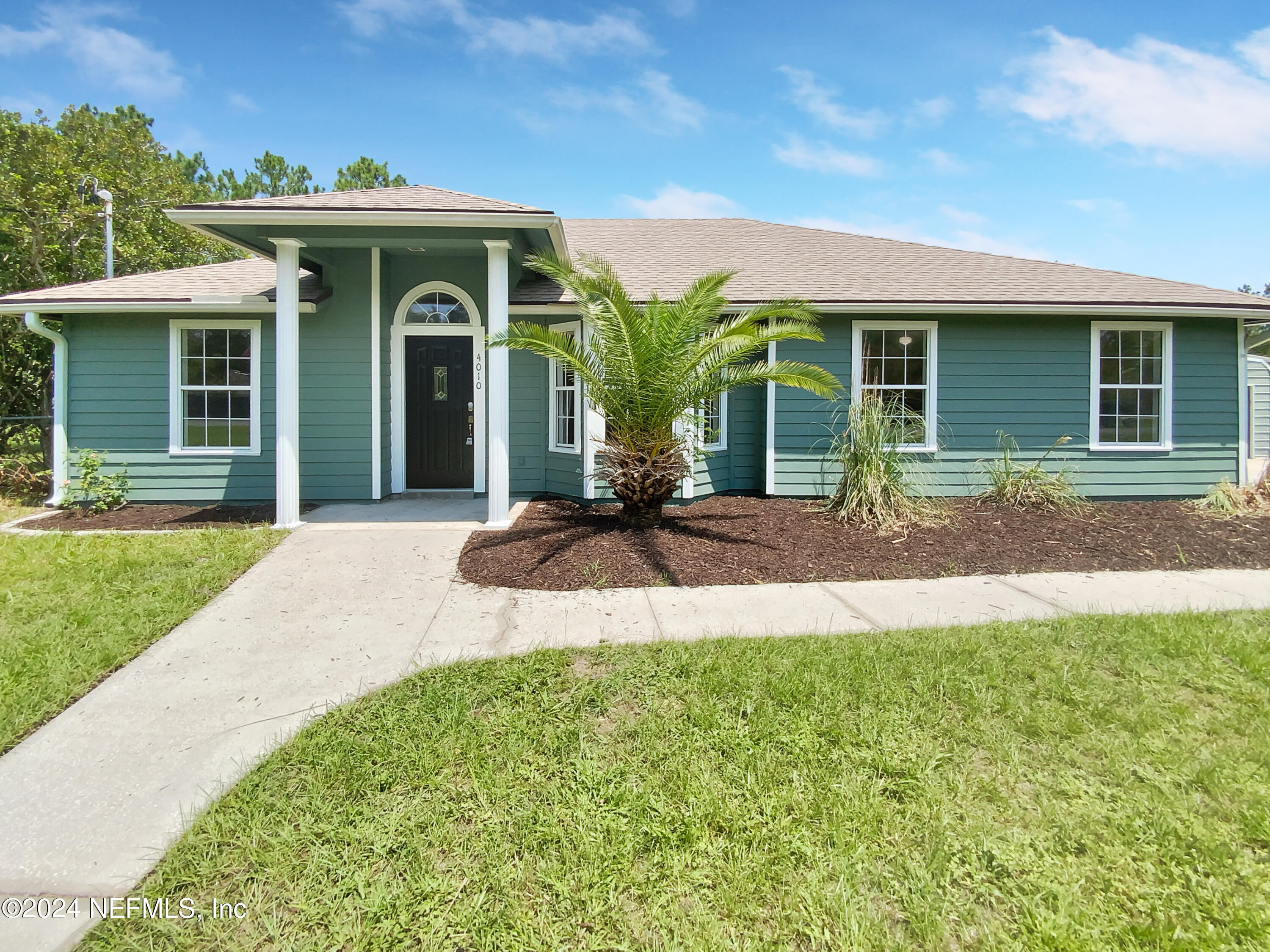 a view of a house with a yard and plants