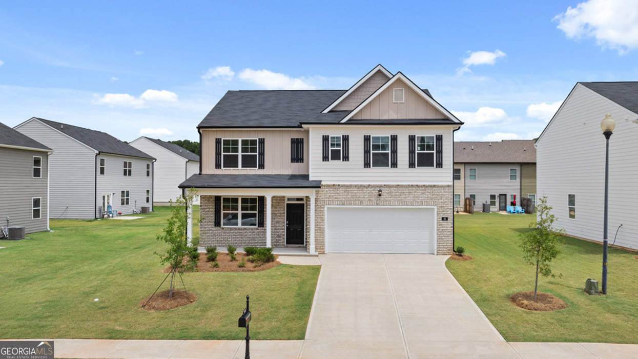 a front view of a house with a yard and garage