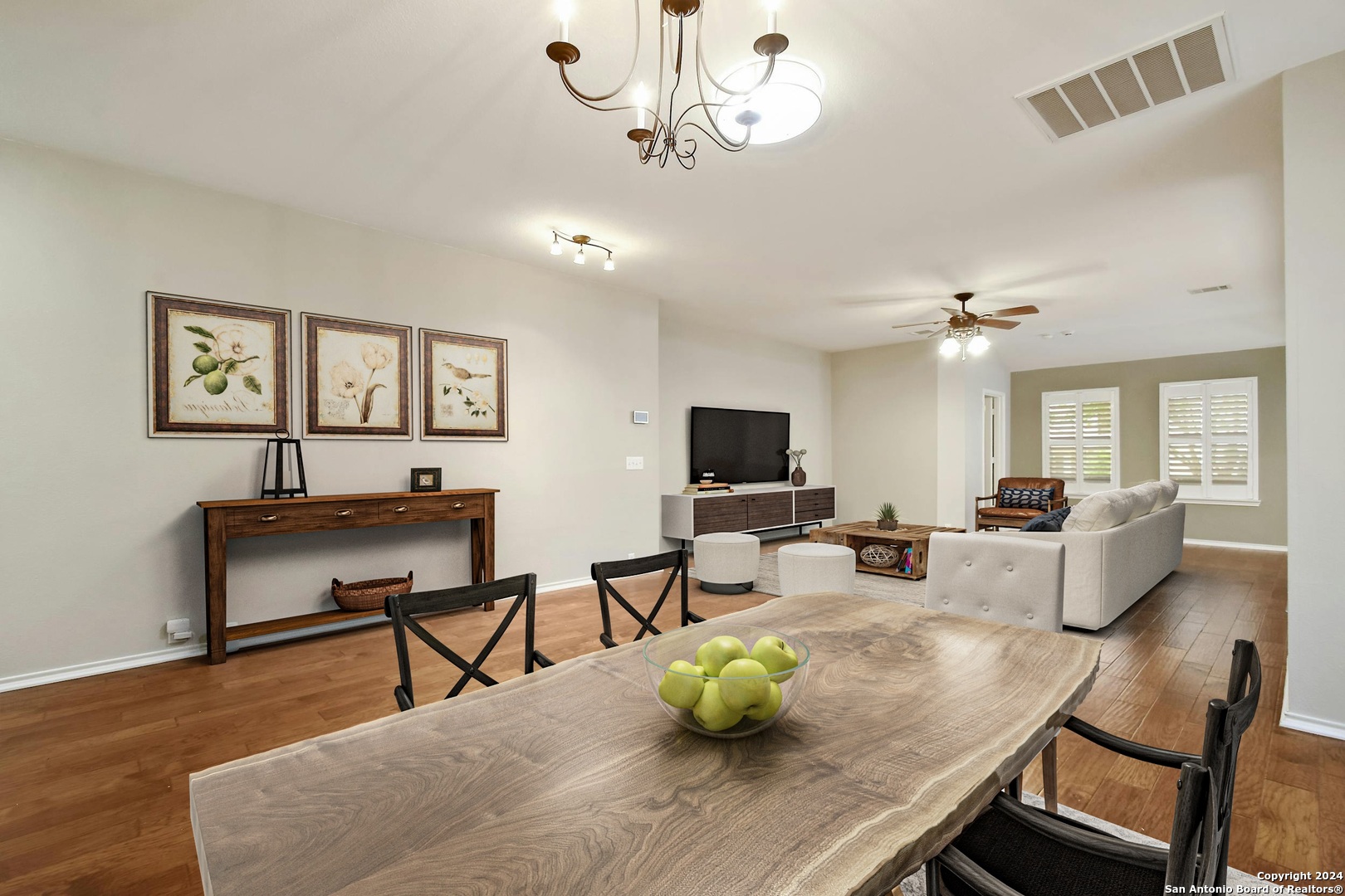 a living room with furniture a flat screen tv and a window