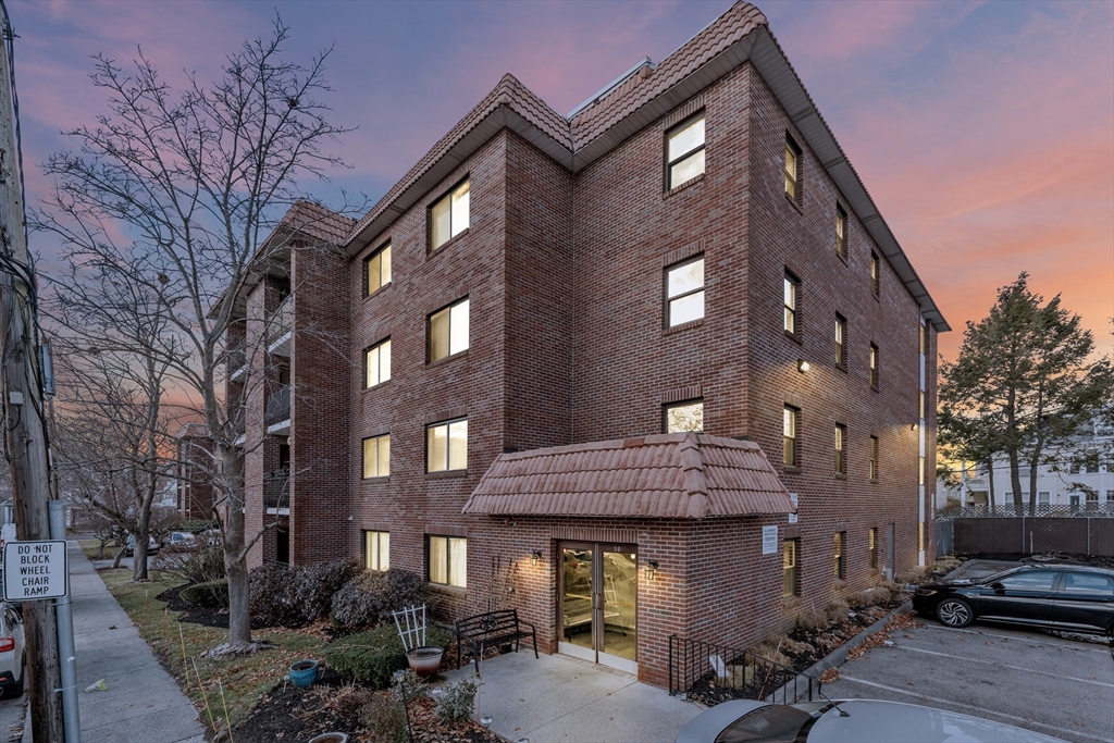 a view of a brick building with many windows