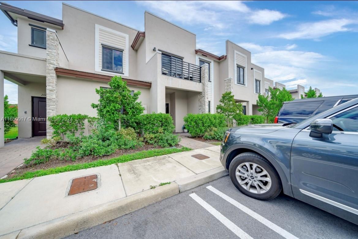 a car parked in front of a white building