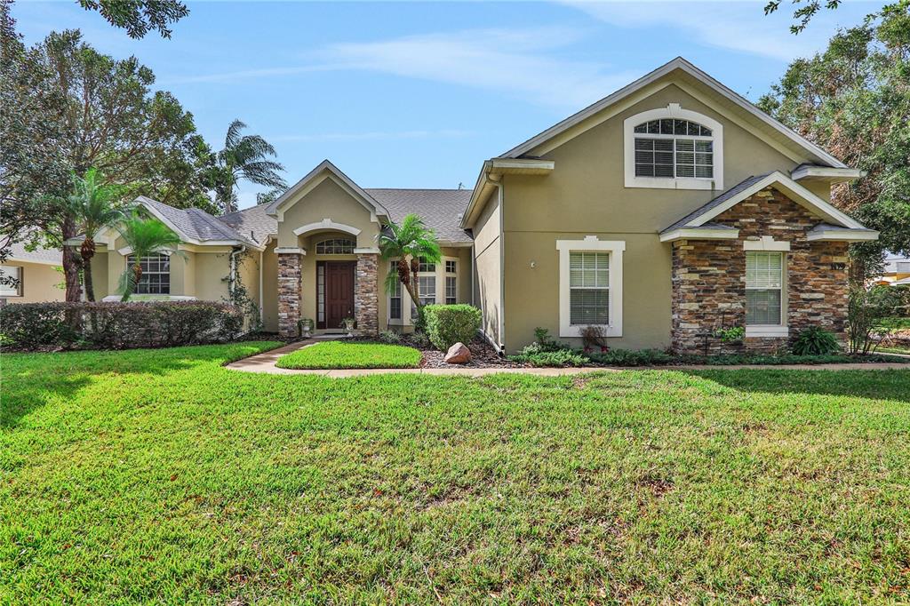 a front view of a house with a yard and garage