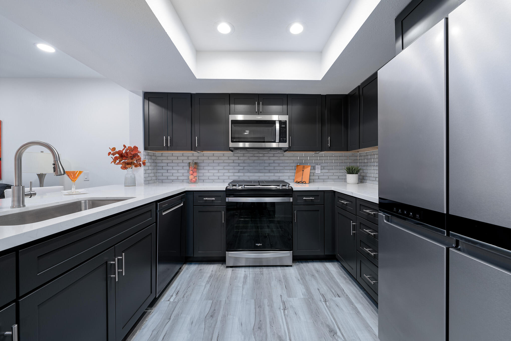 a kitchen with stainless steel appliances a sink dishwasher a stove and cabinets