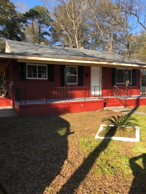 a view of a house with backyard porch and sitting area