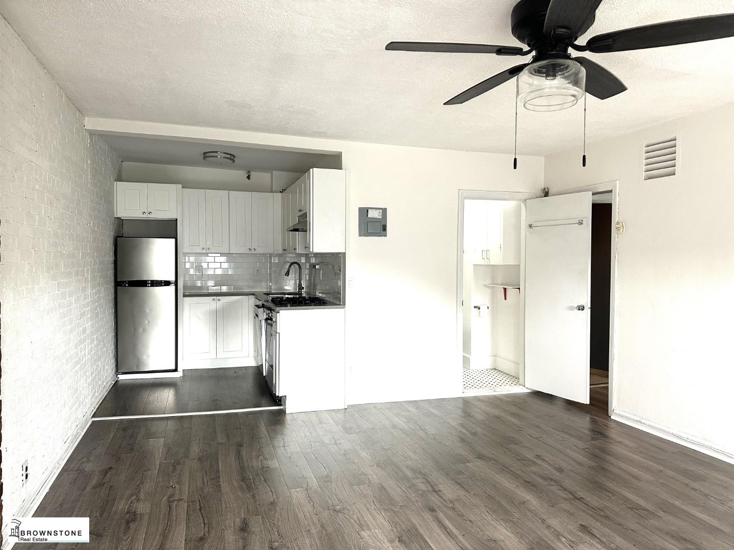 a view of kitchen with stainless steel appliances refrigerator stove microwave and cabinets