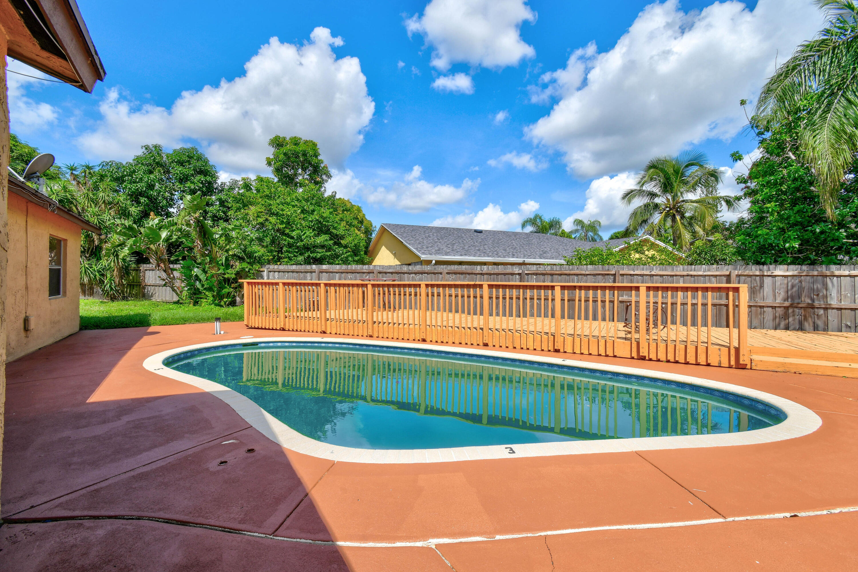 a view of a swimming pool with a patio