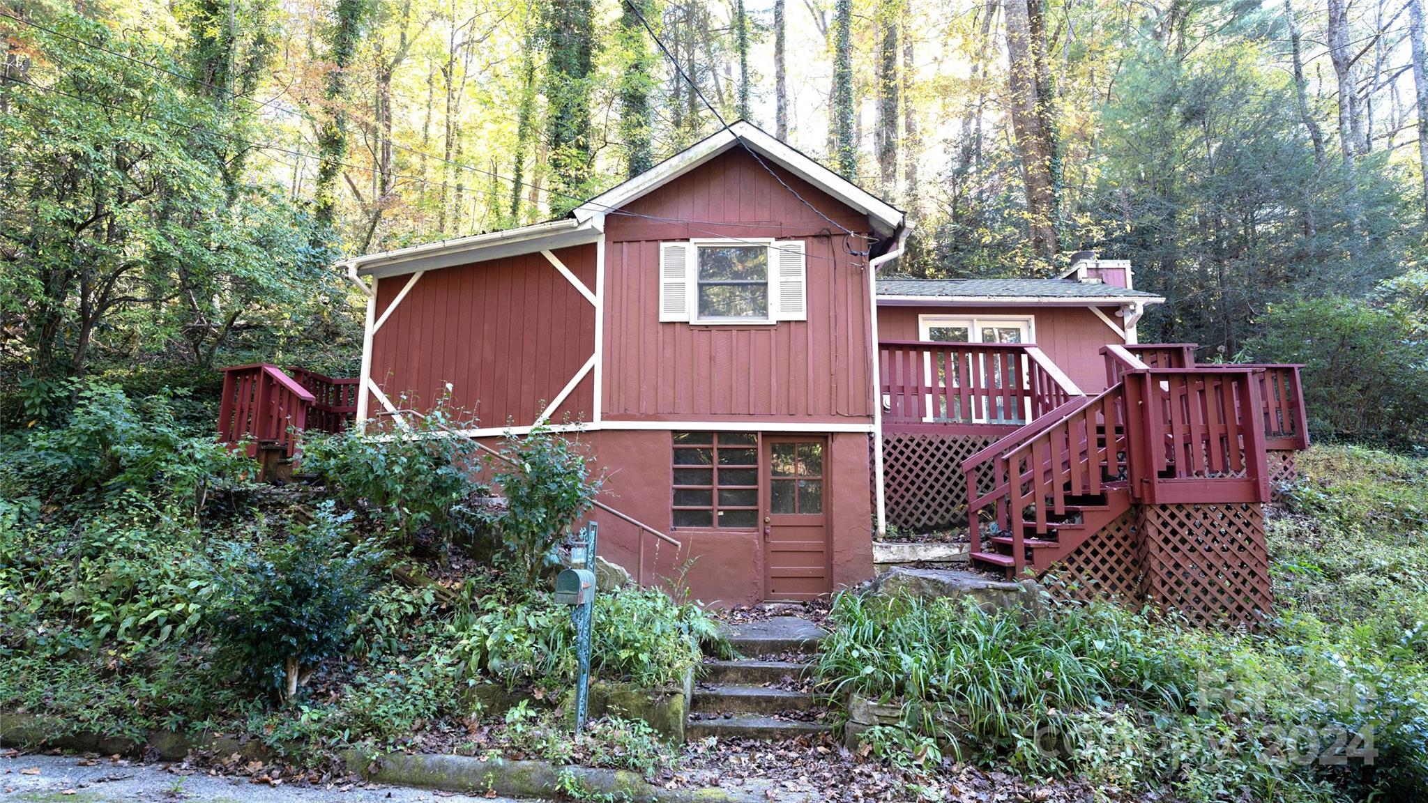 a view of a house with balcony and trees al around