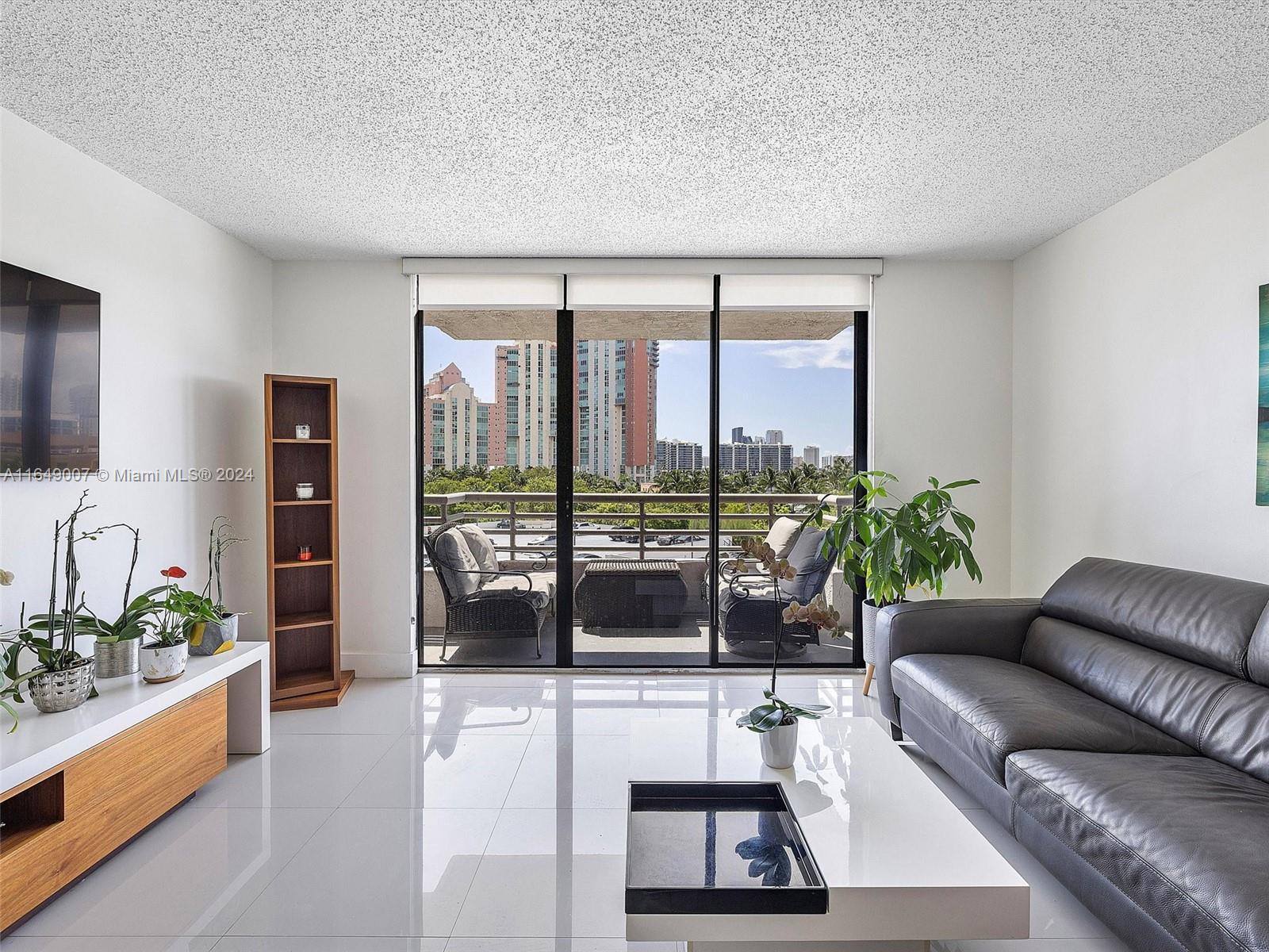 a living room with furniture and large windows