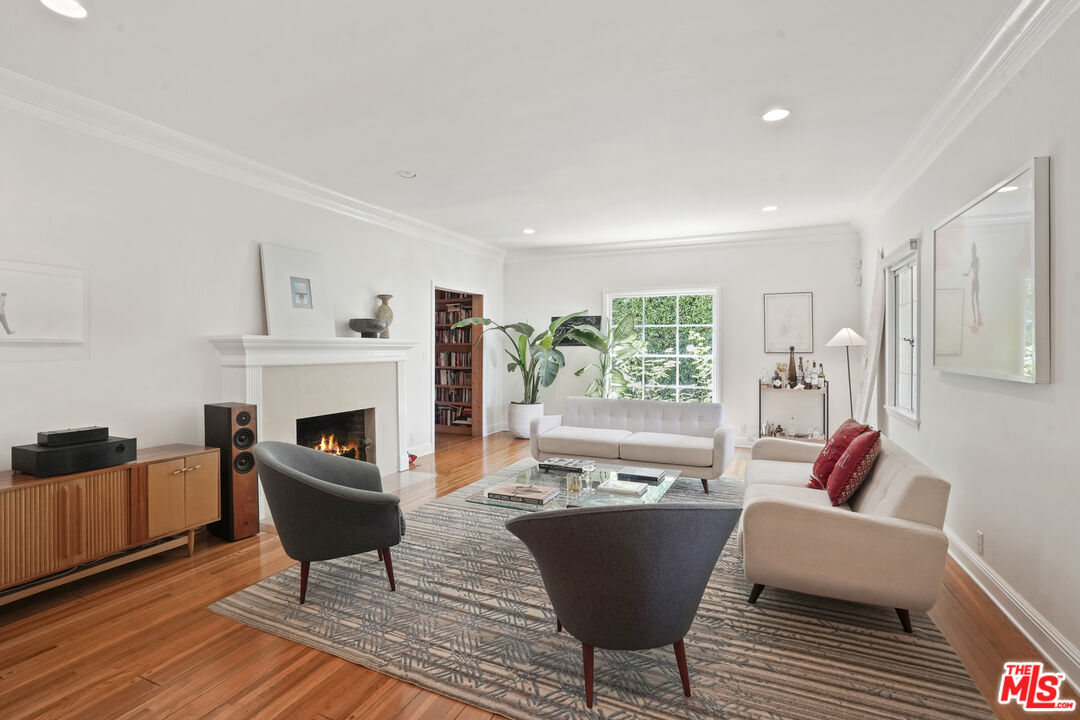 a living room with furniture a fireplace and a table