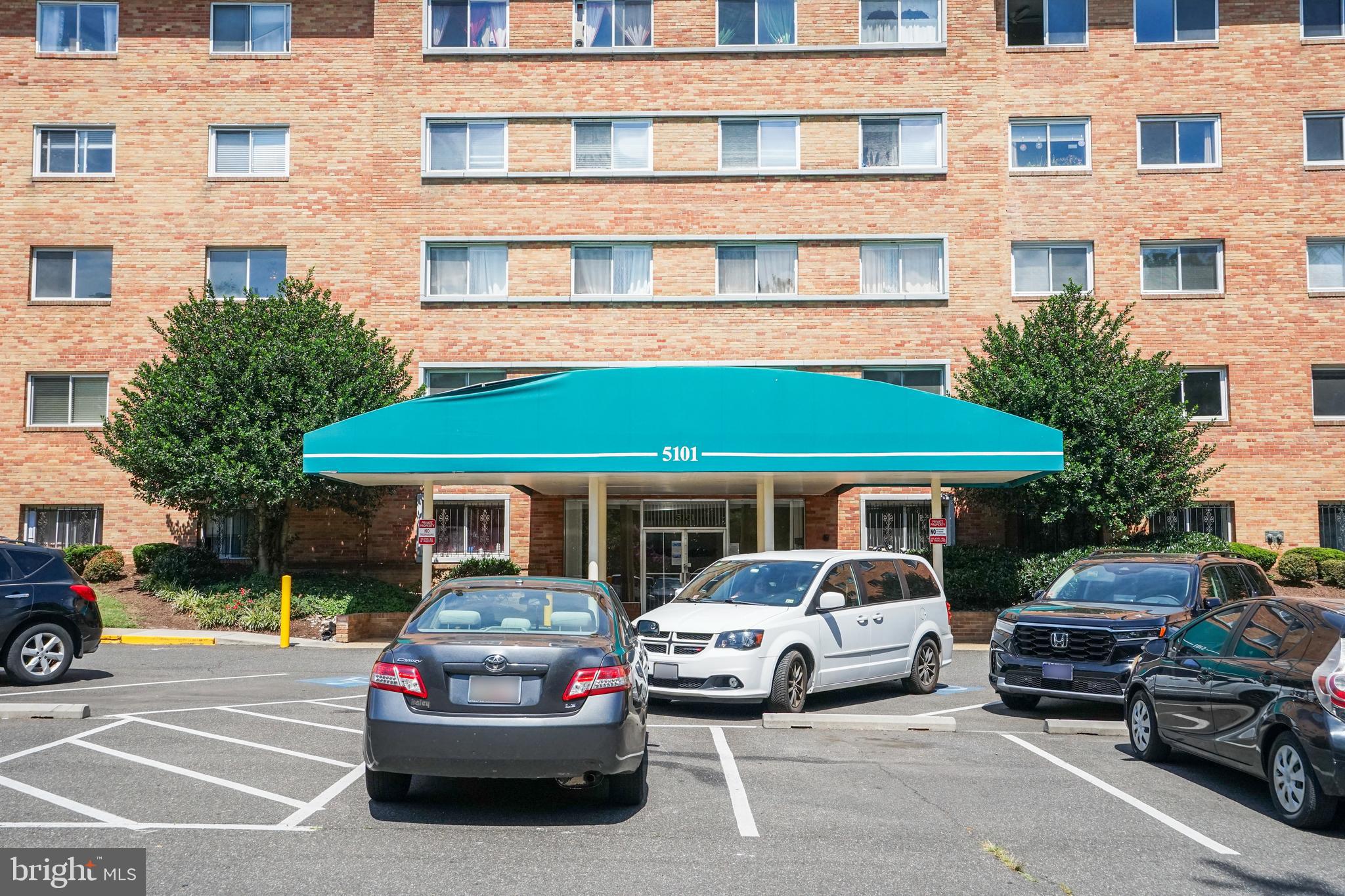 a front view of a residential apartment building with a yard