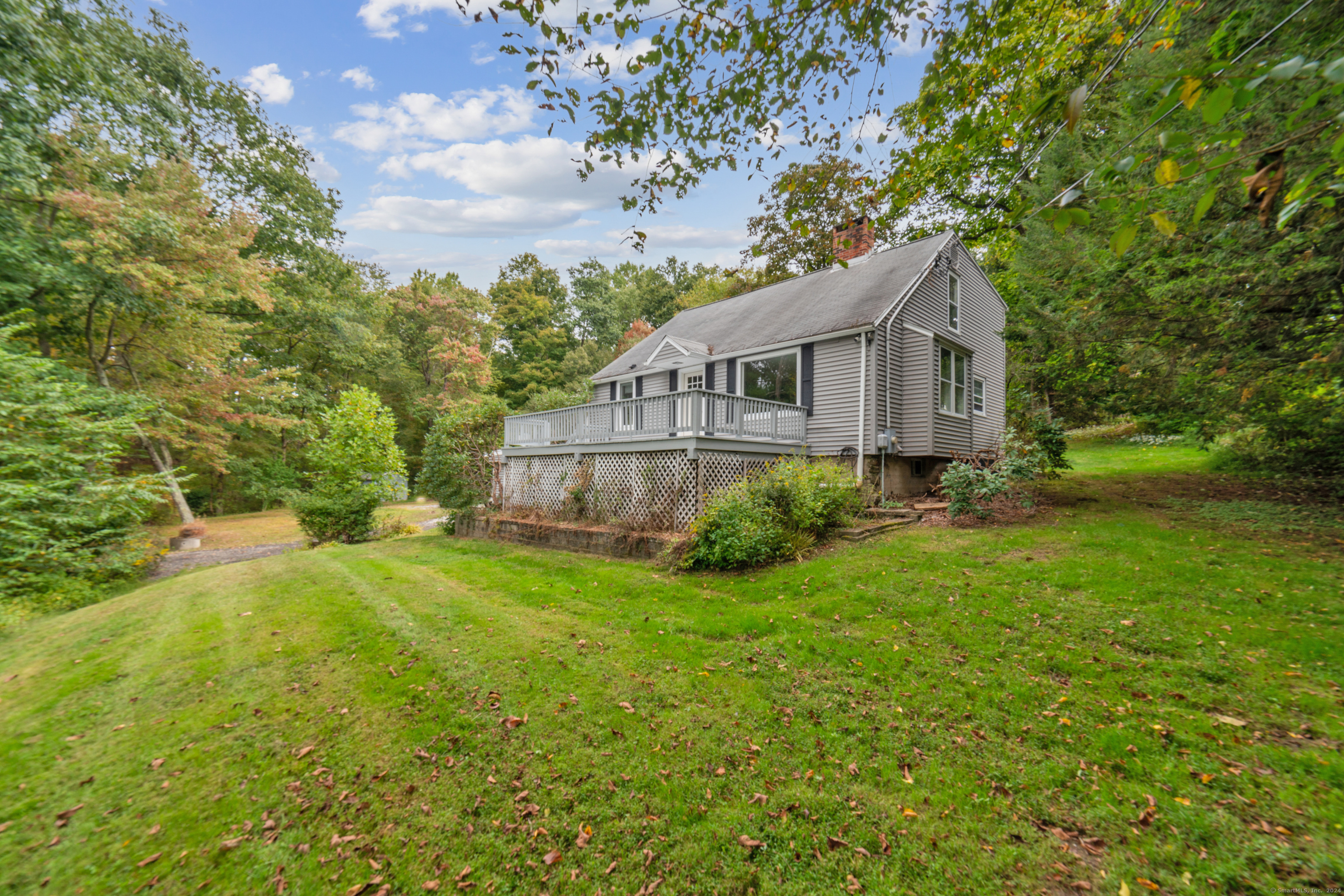 a view of backyard of house with green space