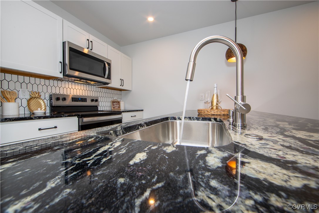 Kitchen featuring stainless steel appliances, whit