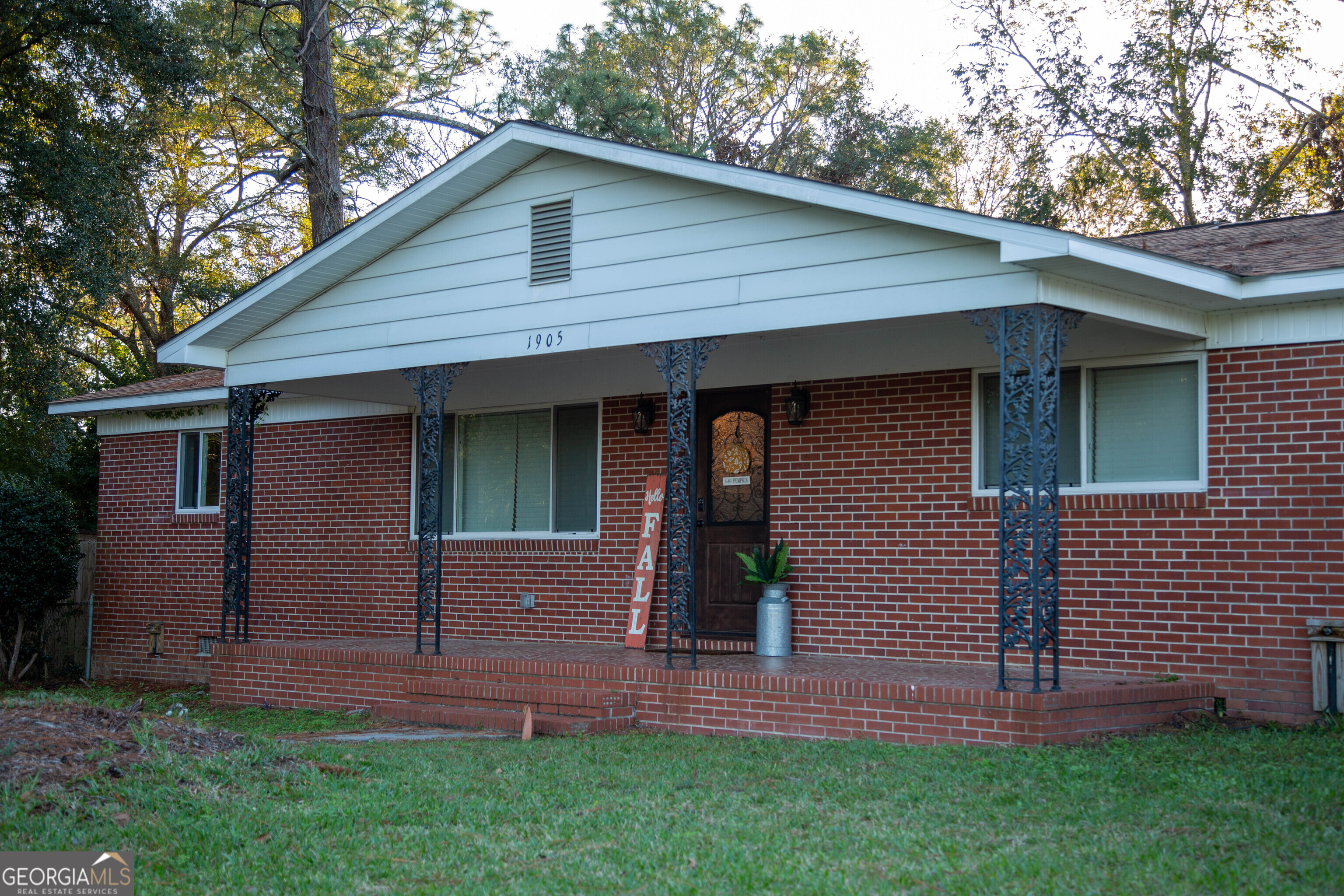 a front view of a house with a garden