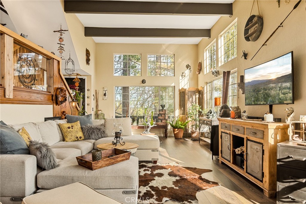 a living room with furniture a large window