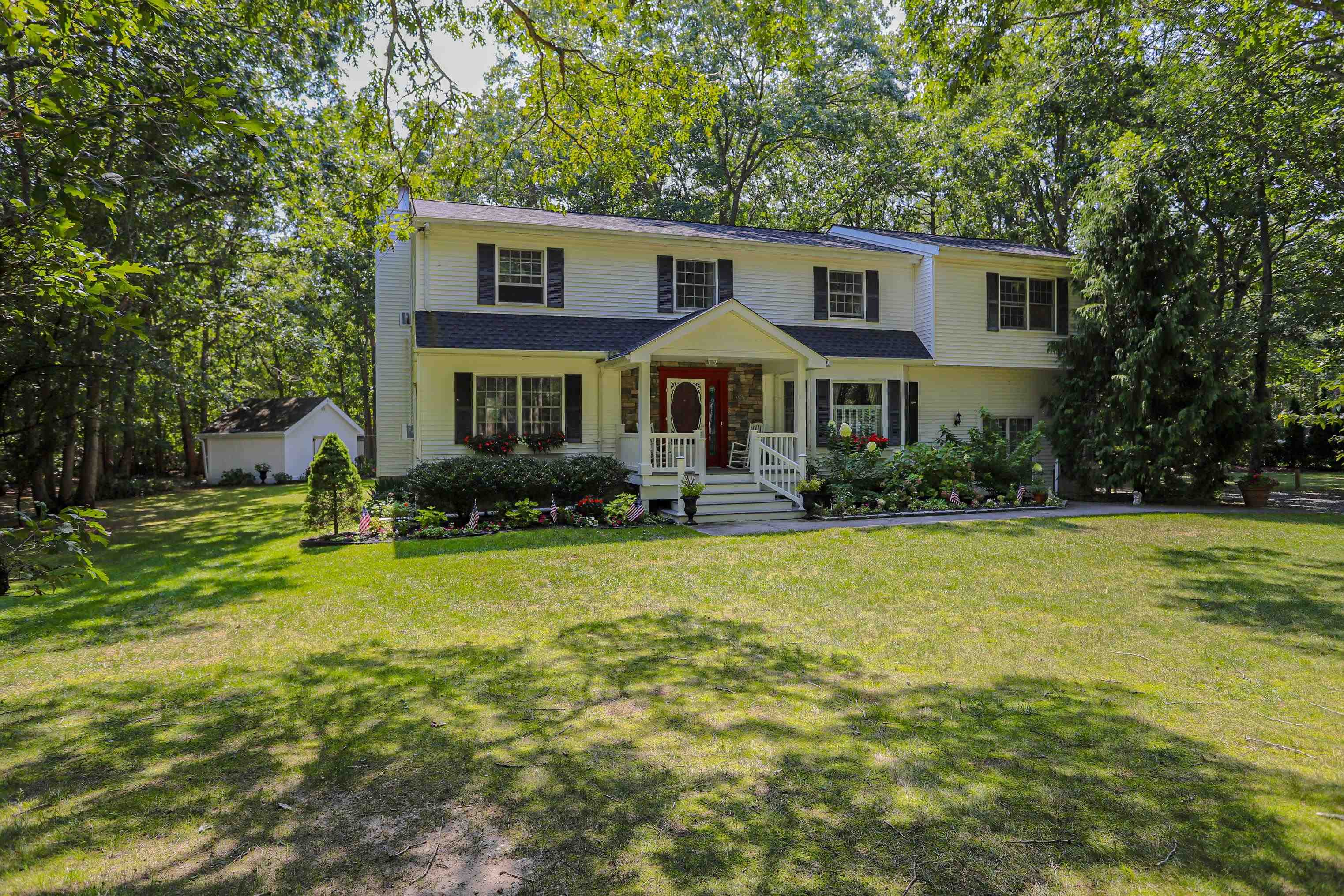 a front view of house with yard and trees