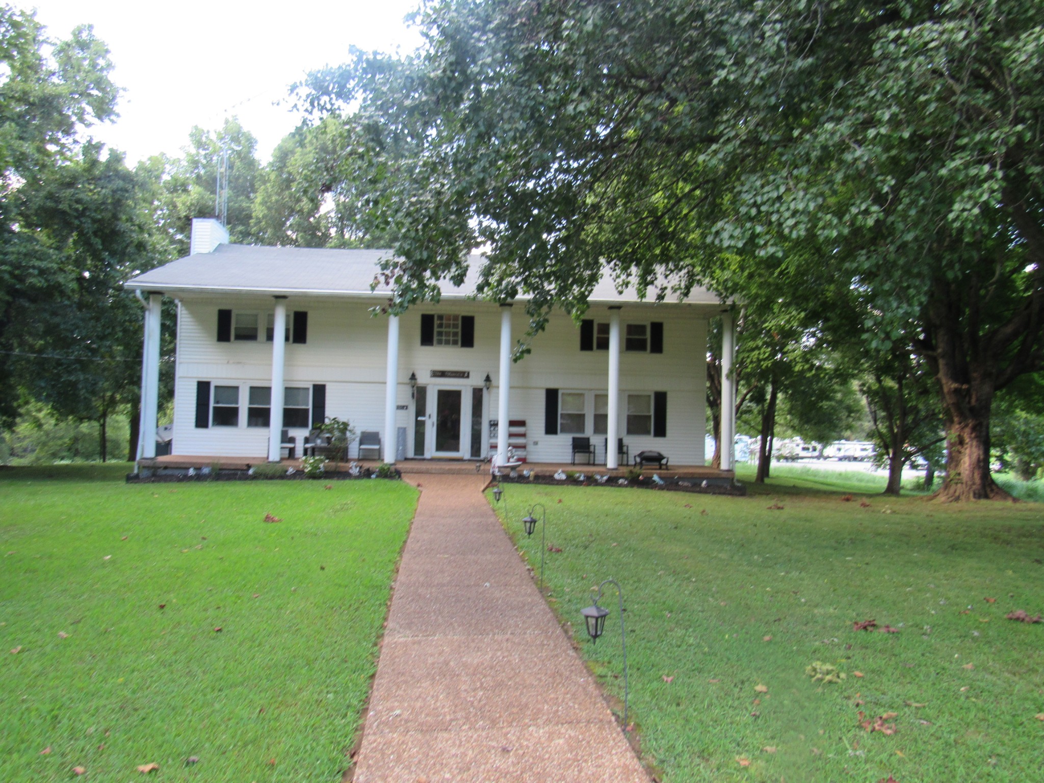 a view of a house with a yard porch and sitting area