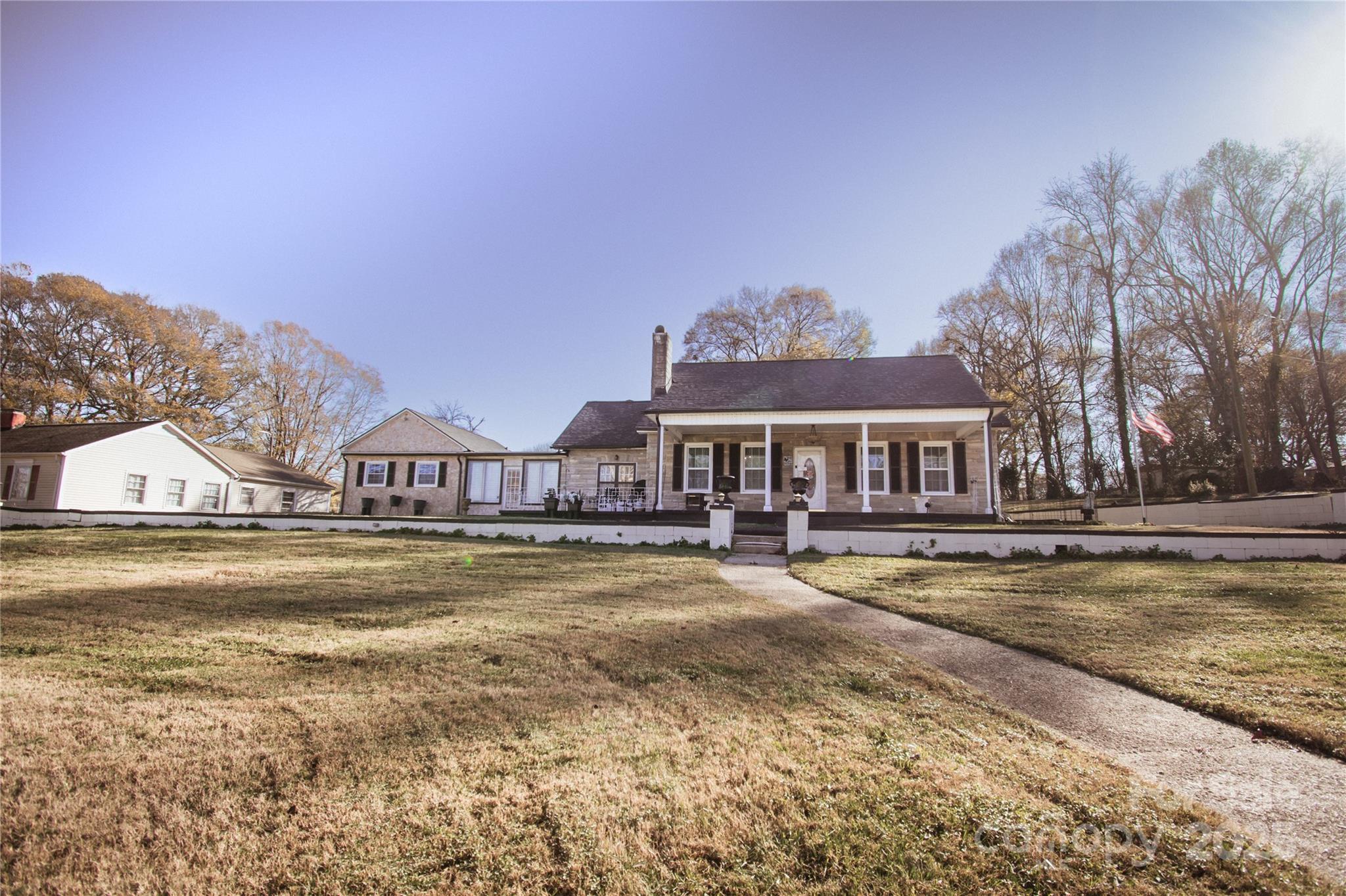 a view of house with outdoor space and swimming pool