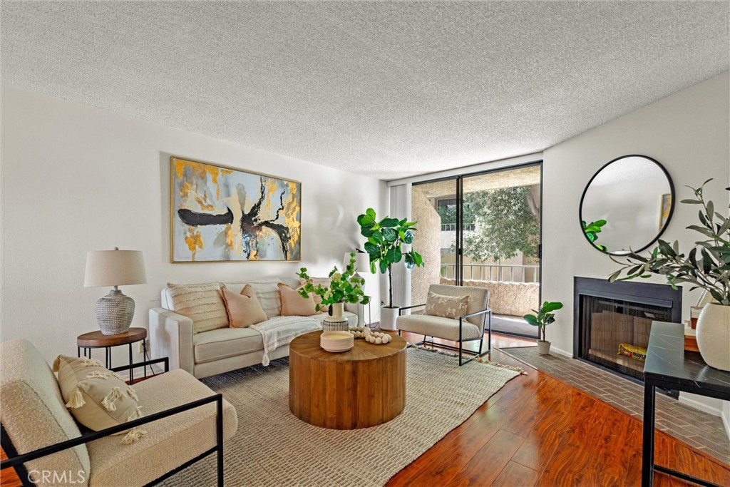 a living room with furniture a large window and a fireplace